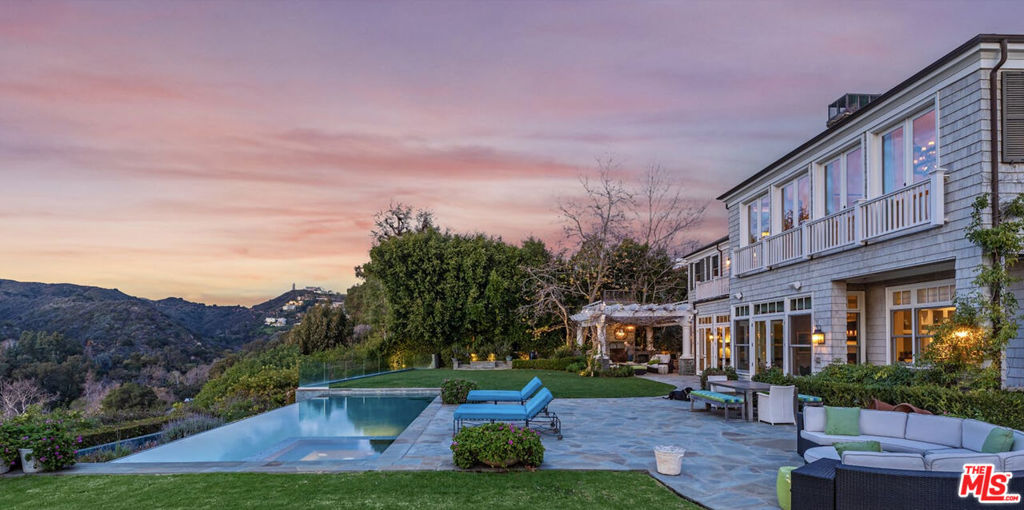 As the reimagined Palisades begins to take root, an opportunity to acquire a coveted Amalfi Rim estate in Pacific Palisades is available for the first time since purchased new by the current owner. This approximately 8,700 square foot East Coast Traditional was built by Scott Harris and designed by Adam Hunter in 2008 and has since been thoughtfully and periodically updated. The approximately 14,000 square foot flat lot enjoys dramatic views of the Santa Monica Mountains and a serene expanse of Will Rogers State Park Features include six bedrooms, eight bathrooms, office, library/second office, gym, theatre and exquisite outdoor living spaces. Systems include upgraded top-of-the line audio visual and security systems, as well as a commercial grade WIFI system. Breathtaking views, streaming light, and a quiet, comfortable elegance make for an extraordinary home just moments from the Brentwood-Palisades border and numerous hiking and biking trails. The adjoining approximately 16,000 square foot flat property with pickleball court is available to be purchased separately.