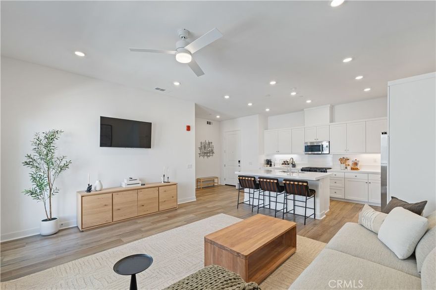 WONDERFUL TOP Floor ONE Bedroom with Valley Views!! Located in the Five Point Community of ELEMENT! Absolutely beautiful finishes on this 1+1 with High Ceilings, Creamy White Walls, & Luxury Plank Vinyl Flooring. Charming Formal Entry with Built-Ins leads to the Great Room. The Expansive Center Island with a Breakfast Bar anchors the White Kitchen which boasts Marble-like Quartz Counter Tops, Stainless Steel Appliances, & Abundant Cabinetry adjacent to the Large Living Room with Views and a French Door that leads to the Balcony Space. There is a Spacious Bedroom with a Gigantic Walk-In Closet, Plush Carpeting and more Views! A Laundry Closet with Stackable Washer & Dryer is included. There is an Extraordinary Private Storage ROOM across the hallway that belongs to this unit! An Attached Single-Car Garage with Electric Vehicle Charging on the first floor that leads to the stairway to the front door. This home includes all the amenities of Five Point's including Pool, Spa, Recreation Center, Sports Courts, Trails, and MORE! Terrific location for commuters. Near to Plentiful Amenities including dining, shopping, & fitness facilities.