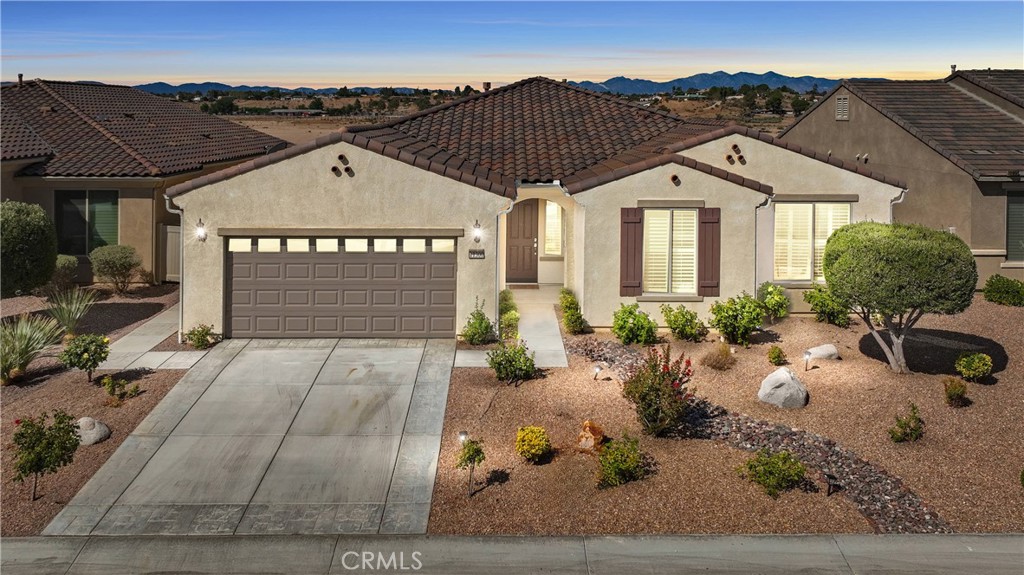 Welcome to one of the largest homes in this highly sought-after 55+ golf course community! This popular (Gathering model) lives up to its name—designed for entertaining and perfect for hosting holidays, family get-togethers, and evenings with friends. Boasting over 2,400 sq ft, this expansive 3-bedroom, 3-bath home features an open floor plan with an oversized game room, ideal for relaxation and fun.
This beautifully appointed home blends comfort and elegance with thoughtful upgrades throughout. The kitchen is the heart of the home, showcasing warm-toned cabinetry, granite countertops, a stylish tile backsplash, stainless steel appliances—including a double oven—and a generous center island ideal for cooking, entertaining, and gathering. The expansive primary suite offers a peaceful retreat with spa-like amenities including a soaking tub, step-in shower, dual-sink vanity, and enhanced privacy. Elegant touches include large custom tile flooring, decorative mirrors (primary bathroom), white plantation shutters, and light-colored engineered wood-like floors that complement any décor. Five-inch baseboards & fireplace add a refined finish throughout. This home is truly move-in ready and designed with everyday comfort and timeless style in mind.
Tucked into the heart of the community, this home boasts a beautiful backyard with stunning views of the local mountains and riverbed. Enjoy outdoor living year-round under the covered patio in your large, landscaped backyard oasis. Beyond the home, residents enjoy resort-style living with access to multiple sparkling pools, the stunning Aspen clubhouse, pickleball and tennis courts, and so much more. A true blend of luxury and lifestyle!