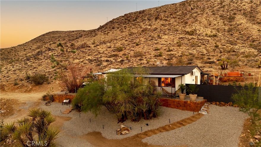 Sawtooth Sanctuary: Perched on the edge of the Sawtooth Mountains, this fully reimagined 2-bed, 2-bath retreat captures sweeping views across Yucca Valley and Joshua Tree. Bright and airy interiors showcase abundant natural light, with seemless flow from interior living to outdoor entertainment. Completely re-designed with high-end finishes, the home showcases abundant natural light, a striking German schmear pebblestone wall in the new kitchen, wraparound fluted travertine tile in the bathrooms and smooth Venetian plaster throughout. Every detail has been considered, blending modern elegance with desert soul. 

A writer’s dream, the setting inspires creativity with endless panoramas and tranquil seclusion. Step from your backyard directly onto hiking trails, with benches tucked into lookout points for moments of reflection above the valley floor. At night, unwind in the cowboy tub beneath dark skies ablaze with stars. Inside, open and luminous living spaces flow seamlessly, designed for both relaxation and entertaining. Whether as a private desert hideaway or a lucrative Airbnb investment, Sawtooth Sanctuary offers a rare opportunity to own a mountain-top retreat where inspiration meets serenity.