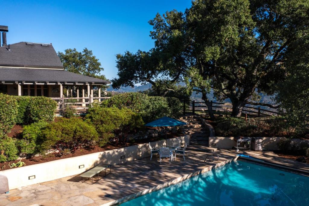 Sunset Magazine's Western Home Award Winner! Perched on 10 acres in Upper Carmel Valley, this stunning property is a restorative sanctuary designed for both ultimate relaxation and effortless entertaining. Imagine resort-like living with panoramic views of the Santa Lucia Mountains and Cachagua Vineyards. Savor your morning coffee with the sunrise, unwind as dusk paints the sunset, or enjoy tranquil moonlit evenings from your expansive porch. The main home offers a warm and inviting escape with beautiful wood walls and vaulted ceilings, creating an atmosphere of rustic elegance. This exceptional property also boasts a perfectly suited guest house for comfortable visitor accommodations, plus an oversized garage with generous storage for all your needs. A pool and spa area completes your private oasis, promising endless enjoyment. Beyond the main residence, this estate is ideal for sustainable living, perfect for cultivating your own garden or housing horses, goats, or chickenstruly embracing the full Upper Carmel Valley experience. This is undeniably one of Upper Carmel Valley's must-see, whether you're seeking solitude or a grand setting for entertaining!
