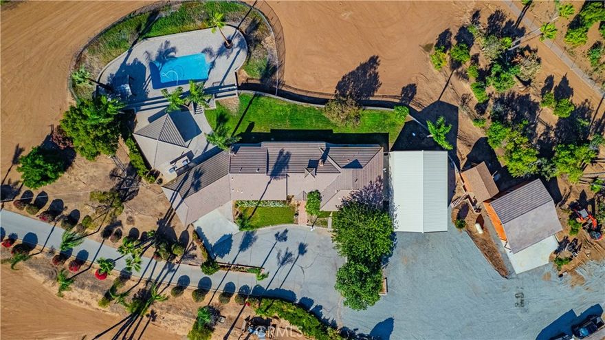 Experience timeless California living at this private Arlington Heights estate, where classic ranch architecture meets breathtaking panoramic views. Nestled on nearly four serene acres, this gated property offers rare privacy and a resort-style atmosphere only minutes from central Riverside.

The interior offers warm natural light that fills every room, highlighting generous living spaces, rich textures, and elegant craftsmanship. The open-concept living and dining areas feature a charming fireplace and expansive glass doors that invite the outdoors in. The kitchen is spacious and functional, designed for both casual family living and effortless entertaining.

Outdoors, your personal retreat awaits — a sparkling pool, two shaded gazebos, and a built-in BBQ set the stage for unforgettable gatherings beneath the palms and stars. 

A fully powered 30x28 detached workshop/garage and separate 50’ covered RV storage with 50amp and sewer adds unmatched versatility, ideal for collectors, creatives, or professionals needing secure workspace and storage. With mature landscaping, long gated drive, and commanding hillside views, 1525 Heather Lane embodies the elegance of rural tranquility paired with the convenience of city living — a sanctuary that truly defines Riverside luxury