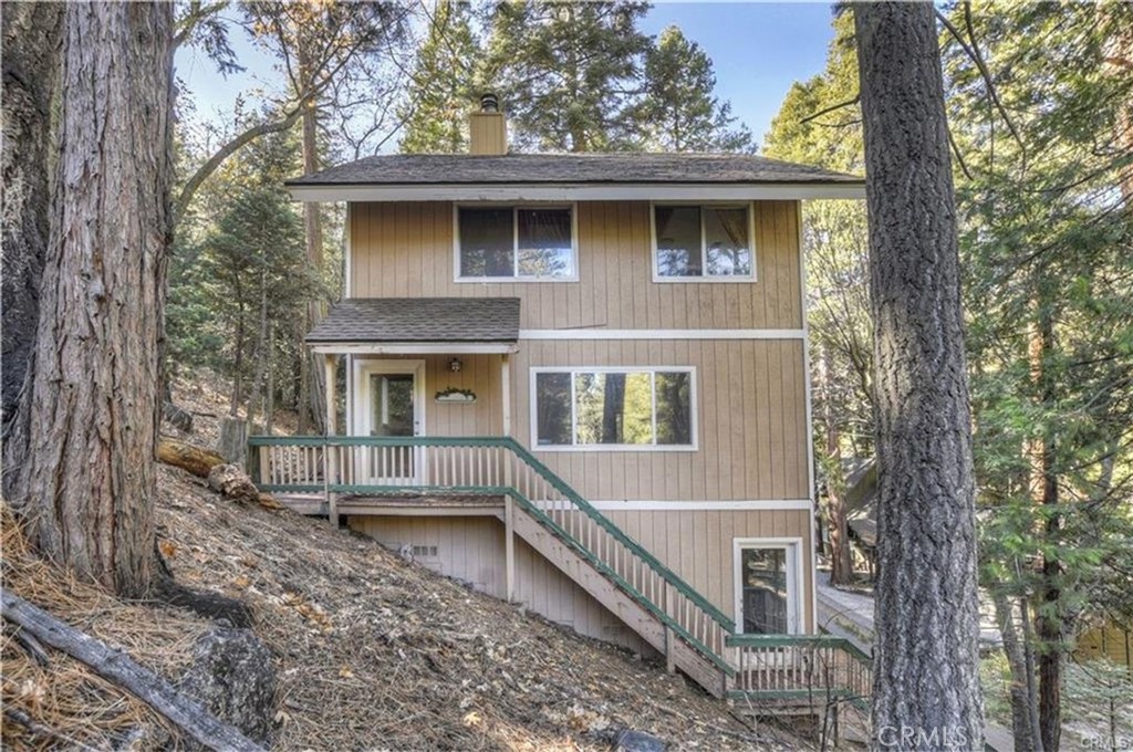 Perfect Chalet
This LAKE RIGHTS'' home is within walking distance of Lake Arrowhead Village & is nestled within the privacy of the tree-tops! A tri-level style home which features a wrap-around deck, an open-airy kitchen w/plenty of pantry & storage space, a counter-top bar for additional seating & designated dining area. The cozy living room features a wood-burning stone fireplace & picturesque forest views which makes this space private & secluded from the street below. This main living area also features a full bath & laundry area w/direct access to back deck for grilling or just relaxing in the hammocks! The upstairs features a full bath, large master bedroom & 2 more bedrooms! The lower level can also be used as a 4th bedroom/family room/game room & has its own access to back deck. The mud room/storage area is large enough to store bikes, kayaks, SUPs & more! New roof, parking for 2 vehicles & can be sold w/furnishings! Plenty of room for family & friends. Would make great vacation rental too!