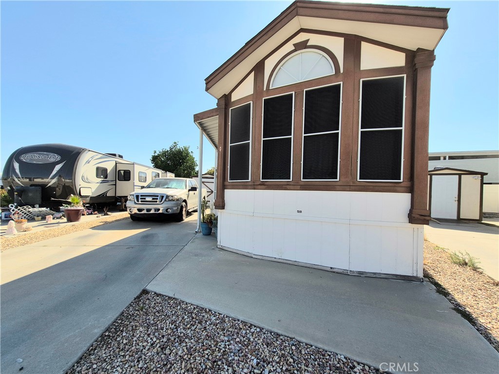 This well maintained Park Model is situated on a Large 'a' Lot with a full Concrete pad Under the home. The Shed Has 220 Outlet And Is Used As Laundry room and storage. Home has newer vinyl plank flooring, 2 Ceiling Fans, Covered Patio and a room that fits a Queen Sized bed. Close to the clubhouse and front gate.