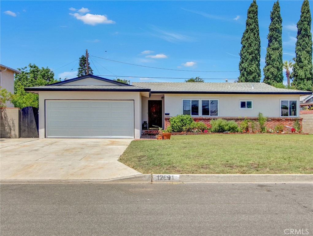 Recently renovated home on a quiet well-established street in the heart of Garden Grove. This home has great curb appeal welcoming you with a charming brick walkway that leads to the front door. As you enter the home you will find beautifully redone hardwood floors with all new recessed lighting throughout, freshly painted interior and exterior. Low-E dual pane windows and sliding doors have been installed throughout the entire house. You are greeted in the kitchen with granite counters and plenty of space to whip up your favorite dish. The family room is freshly painted, new carpet and recessed lighting including the dual pane windows to keep that cold winter out; it is the perfect size for those cozy nights to enjoy sitting by the fireplace. We even offer a completely redone bonus room: approximately 23X14 including insulation, electrical, fresh paint, carpet and even its own heating & air conditioning unit; this large room can be used for multiple functions. The three bedrooms have been nicely redone with warming fresh paint, new carpet and ceiling fans/lighting; these rooms are all naturally well-lit. Both bathrooms have upgraded light fixtures, faucets and paint. The garage is a fully finished garage that has been freshly painted; it even has a new garage door and opener. This home's lovely backyard offers a formidable hedge around the perimeter for plenty of privacy and a covered patio for those evenings of doing some relaxing with a little porch sitting. It even has its own lemon tree. The owner has spared no expense at upgrading this property. Stop by for a visit before it’s gone. Located within a short walking distance of parks and elementary schools. Plenty of shopping and dining nearby. Easy access to 5, 22, and 57 freeways.