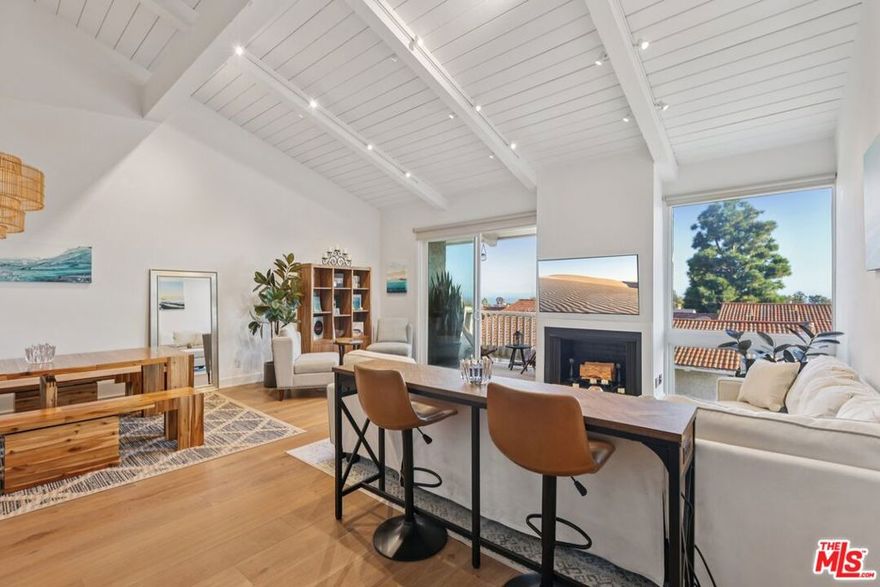 Experience the Best of Coastal Living in this Stunning, Fully Renovated Townhome Located on the Coveted Top row of Malibu Villas w/ Ocean Views! Professionally designed with high-end upgrades throughout.. Enter on the mid-level and ascend the floating staircase to an airy, light-filled great room featuring soaring ceilings, walls of glass, and a beautiful wood-burning fireplace. Step out onto the covered balcony and take in the refreshing ocean breeze and panoramic vistas. New wide-plank wood floors flow seamlessly through the living and dining areas, creating an elegant and inviting space. The designer kitchen is a chef's dream equipped with top-of-the-line stainless-steel appliances, built-ins, a beverage cooler, breakfast bar, corner pantry and utility cabinet. Perfect for entertaining, the open layout connects the kitchen, dining, and living spaces all oriented toward the stunning ocean views. Downstairs, the spacious primary suite offers a serene retreat with its own private balcony, spa-inspired bathroom with jetted tub, dual sinks, walk-in closet plus additional closet, built-in shelving, and plantation shutters. The second en-suite bedroom features a steam shower, plantation shutters, and access to a large, private patio surrounded by lush greenery. Third bedroom situated on the loft level, complete with treetop views and its own bathroom. Additional highlights include: 2-car attached garage with direct access. Laundry area and storage for surfboards and beach gear. Resort-style amenities: pool, spa, remodeled clubhouse with kitchen and sundeck. Guard-gated community with ample guest parking.  Just cross PCH to Paradise Cove and short distance from Zuma Beach, Point Dume, Broad Beach, Pepperdine University, and Malibu's best restaurants and boutiques.  This turnkey residence offers the perfect blend of luxury, comfort, and location. Live your Malibu dream lifestyle available now.  Priced for unfurnished and can come furnished at a premium, please inquire.  Must see to experience the best of Malibu Beach Living!