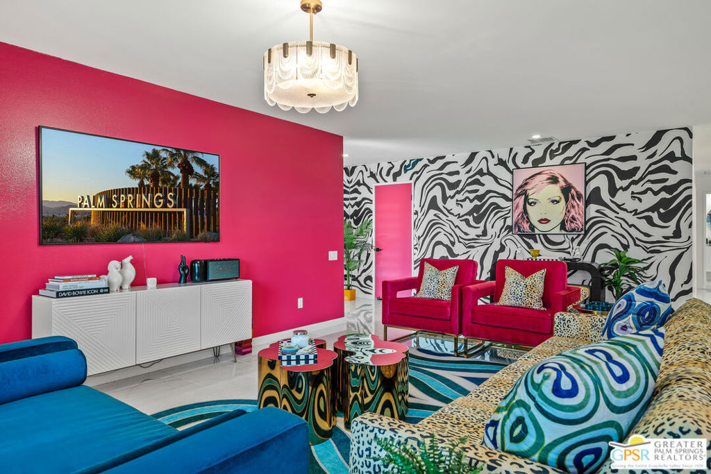 Discover this rarely available 3-bedroom, 2-bath William Cody-inspired end-unit condo nestled in the gated Palm Springs Country Club. Spanning nearly 1,700 sq ft, this glamorous residence feels like a single-family home. The open, light-filled layout boasts large living and dining spaces that flow into lush patios and greenbelts, perfect for modern desert living and entertaining. Significant upgrades completed in 2024 elevate comfort and style. The kitchen is entirely renovated, featuring high-quality appliances, custom cabinetry, designer countertops, and modern lighting, which connects seamlessly to the social areas. Both bathrooms are fully updated and showcase stylish vanities and sleek tile work, with new electronically controlled bidet-like toilets, ensuring a spa-like feel. Throughout this colorful condo, you'll find new tile flooring and upgraded plumbing fixtures for added convenience and style. Recent enhancements also include a water softener system, washer and dryer ducting with hookups, and security shutters installed on select sliding glass doors. The climate system was fully replaced with a new two-stage HVAC in the attic, all new ducting, vents, fresh insulation, and a smart thermostat for energy efficiency and comfort. All electrical systems have been replaced and upgraded, including the panel, breakers, switches, outlets, and lighting, making everyday living safer and easier. You're just steps from a sparkling pool and spa surrounded by beautifully maintained landscaping, yet only a short drive from shopping, dining, golf, and downtown Palm Springs. The property sits on fee simple land - no land lease and allows for short term vacation rentals. This cool condo blends iconic mid-century style, substantial upgrades, tranquil views, and a sought-after community setting ready for full-time living, a luxurious second home, or an attractive rental. Schedule your tour today and embrace the best of the Palm Springs resort lifestyle in a home that truly stands out.