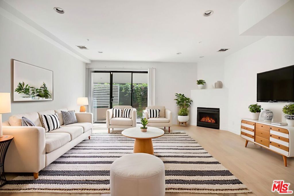 Location! Location! Welcome to an exceptional two-story townhouse ideally located in one of Santa Monica's most coveted neighborhoods. This spacious 2-bedroom, 2.5-bath home is situated in a secure, controlled-access building just a stroll away from the boutique shops of Montana Avenue, the vibrant 3rd Street Promenade, and the sandy shores of the beach. Upstairs, you'll find two generously sized bedrooms, each with walk-in closets, private balconies, and skylights that flood the space with natural light. Both bedrooms have their own full bathrooms, richly enhanced with granite countertops. Convenient in-unit washer and dryer are also located upstairs. Downstairs, the large living room is the centerpiece, featuring a gas fireplace and recessed lighting, and opens onto a private outdoor patio perfect for relaxing or entertaining. There is also a powder room on the main level for guests. Comfort is assured with central air conditioning & heating throughout. Additional highlights include side-by-side gated parking, offering both security and ease, plus controlled building access for privacy and peace of mind. This home blends elegant finishes, thoughtful design, and an unbeatable location. Don't miss this opportunity to experience Santa Monica living at its finest.