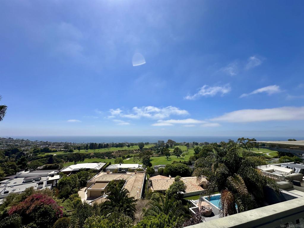 Welcome to your dream home in beautiful La Jolla, where breathtaking panoramic views of the ocean, beach, and lush golf course below set the tone for everyday luxury. This stunning 4-bedroom, 3-bathroom residence offers over 3,000 sq ft of elegant living space designed for both comfort and style. Enjoy two expansive decks, perfect for soaking in the views or entertaining guests. Inside, you’ll find soaring high ceilings, new flooring, and large windows that flood the home with natural sunlight. The spacious layout includes two fireplaces, ample storage throughout, and a backyard oasis adorned with palm trees and vibrant succulents. The gourmet kitchen is a true chef’s delight, featuring top-of-the-line stainless steel Viking appliances, including a commercial-grade Viking stove — ideal for hosting and creating unforgettable meals. Retreat to the primary bedroom suite, complete with its own bathroom and a massive walk-in closet with a custom built-in shelving system. Additional highlights include laundry hookups, a two-car garage, and a layout that makes this home a family haven and entertainer’s paradise. Don’t miss the opportunity to live in one of La Jolla’s most coveted locations, just minutes from the beach, world-class golf, and coastal charm.