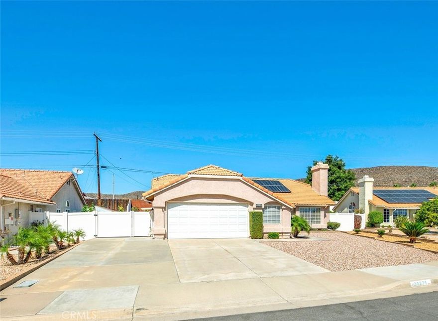 Beautiful and Rare 3 Bedroom 2 Bathroom Home with Gated RV Parking located in the highly desirable 55+ Age Serenade Community within the heart of Menifee . This home is within a 55+ Community but does not have an HOA and offers Low Taxes. Step inside to a light filled home with an open floor plan . The upgraded tile flooring flows throughout the high traffic areas including family room , kitchen , hallways and bathrooms with carpet in the Living Room, Dining Room and all bedrooms. The spacious living room is located at the front of the home with a cozy fireplace.

The hallway leads to 3 spacious bedrooms . The  first bedroom is privately located for guests or a home office.  Double doors open to the spacious primary suite with en-suite bathroom offering double vanities, luxurious soaking tub, and walk in shower plus a generous sized walk in closet . 

Your kitchen features lots of cabinets,pantry , abundant counter space , stainless steel appliances , large dining area , and open to the family room with large windows and views of your tranquil backyard . Enjoy serene outdoor living with easy to maintain front landscape and relaxing backyard with beautiful landscape and fruit trees to enjoy from your Alumnawood Patio stretching the entire length of the home plus a large side yard with shed. 

Additional highlights of this home is the inside laundry room , oversized 2 car garage with workshop , NEW AC unit in 2022, and Affordable Energy Efficient Solar Power Purchase Agreement keeping your home energy bills low . Don't miss this wonderful home and community !!