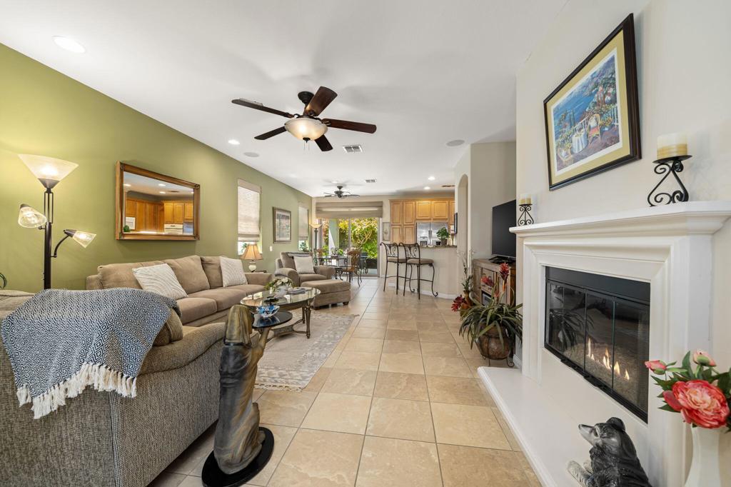 This beautifully-maintained San Ysidro model in the highly sought-after 55+ community of Sun City Shadow Hills is offered FURNISHED. Ideally located across from a greenbelt and near the dog park, this inviting home offers two spacious bedrooms + a versatile DEN, two baths, and ample living space. The primary suite offers a spacious en-suite bath, large walk-in shower, and walk-in closet, while the kitchen features a gas cooktop, double-wall oven, STAINLESS STEEL REFRIGERATOR, and generous counter space ideal for entertaining. A separate laundry room with utility sink, washer, and gas dryer adds convenience, and the two-car garage includes BUILT-IN CABINETS and a water-conserving hot water recirculating pump. Interior highlights include custom designer paint, extended Italian porcelain tile floors, a cozy FIREPLACE with reflective fire glass, SURROUND SOUND in the Great Room, and ceiling fans throughout, including the patio. Recent updates bring peace of mind with a NEWER HVAC CONDENSER (2022), York furnace blower (2025), Lift Master garage door motor (2024), newer refrigerator (2021), garbage disposal (2022), clothes washer and thermostat (2022). The private backyard is beautifully landscaped with lush lawn, mature Plumeria trees, low-voltage lighting, upgraded hardscape, and a soothing fountain with remote. Enjoy resort-style living with access to golf, tennis, pools, fitness centers, restaurants, social clubs, and more. Move-in ready and waiting for you to live the lifestyle you deserve! Schedule a private tour today!
