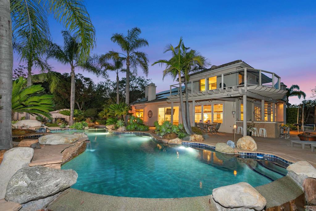 Rancho Verde Estate with Amazing Pool on Nearly an Acre, No HOA, Solar, Tesla Charger and Powerwall! Discover this beautifully upgraded 5-bedroom, 4-bathroom home for sale in Rancho Verde Estates, one of North Escondido’s most desirable neighborhoods. This spacious 3,663 sq. ft. estate home features an open-concept floor plan with soaring ceilings, designer lighting, and a completely updated chef’s kitchen with quartz countertops, custom cabinetry, high-end appliances, and an oversized island perfect for entertaining. The luxurious primary suite is conveniently located on the first level and offers direct access to the backyard oasis, perfect for enjoying morning coffee or evening sunsets by the pool. This home is equipped with solar panels (30 owned, 17 leased) dramatically reducing energy costs while providing sustainable living. Additional upgrades include a whole house water filtration system and water softener, ensuring clean, high-quality water throughout the home. The property offers true resort-style living with a sparkling pool, expansive patio, lush landscaping, and peaceful mountain views. The large private lot provides space to relax and entertain, all just minutes from Lake Hodges, I-15 freeway access, shopping, dining, and top-rated schools. Priced at $1,899,000, a rare opportunity to own a solar-powered estate in Rancho Verde Estates at an exceptional value.