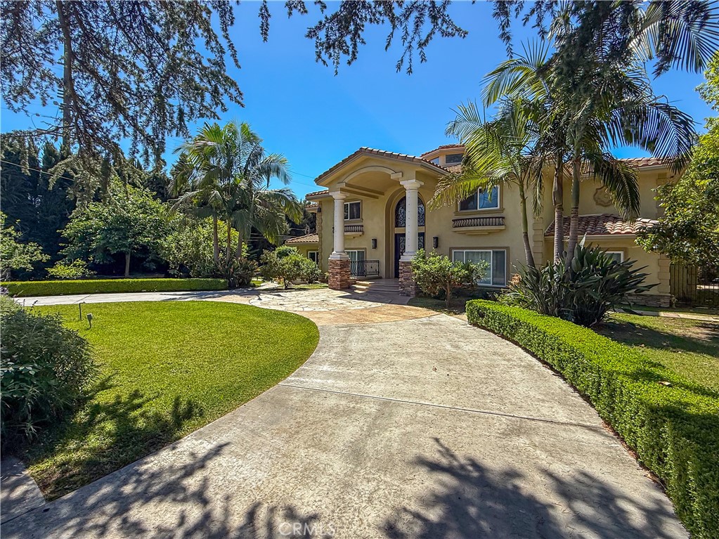 Welcome to 202 W Lemon Ave., a breathtaking estate in the heart of Arcadia, renowned for its award-winning Arcadia Unified School District. Situated on a sprawling lot behind an automated wrought-iron gate, this magnificent residence showcases timeless elegance, modern luxury, and over $1 million in custom upgrades. Designed with guidance from a Feng Shui master, the interior and exterior layouts harmonize energy and flow for prosperity and well-being. A circular driveway leads to a stately façade and a dramatic double-height foyer adorned with imported Italian crystal chandeliers and exquisite marble flooring. To the right, a soaring formal living room with fireplace and display cabinets flows into a charming piano room. A guest suite and refined office with dual desks and built-in shelves offer privacy and access to the serene backyard. At the heart of the home lies a spacious family room designed for upscale entertaining, complete with a sleek bar, KitchenAid fridge, Miele coffee machine, wine cooler, designer fireplace, and a striking TV feature wall flanked by sliding glass doors. A premium karaoke sound system adds to the fun. The formal dining room and cozy breakfast nook lead into a chef’s kitchen—featuring Thermador appliances, Sakura dual sterilizer, Fotile cooktop and hood, modern cabinetry, dual sinks, and a large laundry room. Another en-suite bedroom with elegant built-ins completes the main floor. An artful staircase leads to the second level, where a lavish primary suite awaits with vaulted ceilings, fireplace, dual walk-in closets, sitting area, and balcony views of the landscaped backyard oasis—complete with a custom pool, shaded pavilion, and pro-grade BBQ station. The spa-like bath features dual vanities, two private toilet rooms, a huge walk-in shower, and a jetted tub. Two more luxurious en-suite bedrooms provide comfort and privacy. Additional highlights include a three-car garage, fully paid solar panel system for energy efficiency, whole-house water softener, and two EV charging stations—one in the front yard and one inside the garage. Located within walking distance to top-rated Baldwin Stocker Elementary and in a neighborhood that has nurtured many Ivy League-bound students, this home offers rare educational and lifestyle advantages. 202 W Lemon Ave. is more than a residence—it is a sanctuary of prestige, harmony, and refined living in one of Southern California’s most desirable communities. Must See to Appreciate!