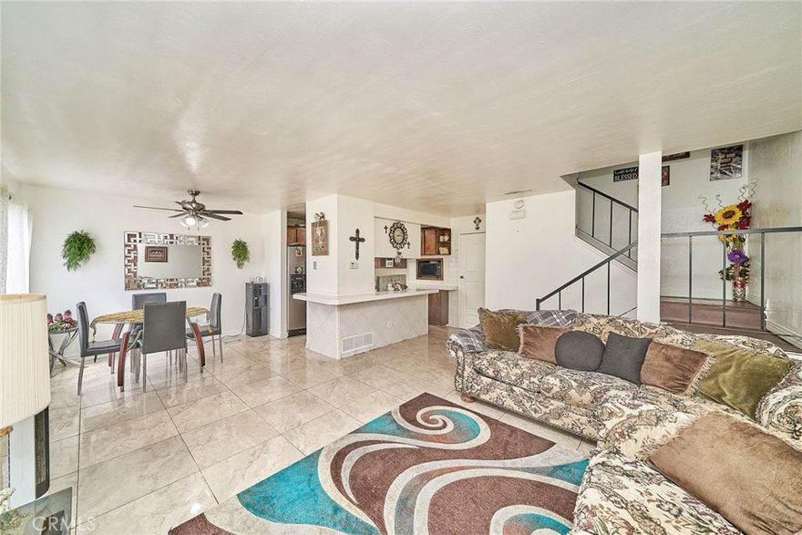 Welcome to this charming and move-in-ready condo in the gated Queen Anne community. This two-story home combines character with modern convenience. Approx. 1,223 sq ft of living space features 3 bedrooms and 1.75 bathrooms. The original garage has been converted into an additional bedroom on the main level. An open living and dining area flows into the kitchen, which is equipped with white tile counters, a stainless steel sink, and a breakfast bar for casual dining. There is under-stair storage on the staircase. Upstairs features the master bedroom with a closet and ceiling fan, as well as a second full bathroom and a secondary bedroom. Central heating & cooling, and in-unit laundry (in a closet). Private gated entry, community pool, 1-carport parking, and multiple parking spaces for additional cars or Guest parking. The Backyard is fenced and private, with no neighbors directly behind the unit. located with easy access to the 60 and 91 freeways for commuting. Shopping, dining, services, and amenities are nearby. Schools in the area include Jackson Elementary, Chemawa Middle, and Ramona High School.