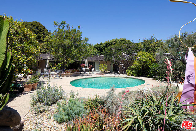 Sprawling single story California Ranch on expansive, very private, extremely sunny 26,463 square foot flat lot on a quiet cul-de-sac in bucolic Sullivan Canyon. Deep setback, huge yard, gorgeous gardens, mature fruit tree orchard and peaceful canyon setting. Many of the signature elements of the Ranch style can be found here: open floor plan for living and dining, floor to ceiling glass that brings light and nature in, four fireplaces and seamless integration of indoor and outdoor spaces. 4 bedrooms, 4.75 baths, including spacious master that overlooks the beautiful yard and has a large bath and walk-in closet. All-tiled kitchen, spa/gym room, sun-filled art studio and detached two room guest house. Potentially zoned for up to four houses and in close proximity to the riding ring and Santa Monica mountain trails, this property represents a very rare offering in prime Sullivan Canyon. A true country feel in the heart of the city. First offering in 58 years.