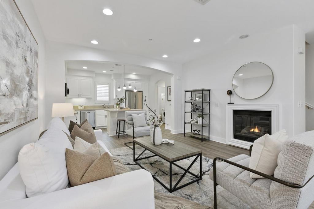Modern, Silicon Valley Living Awaits in this Luxury Residence! Located on a tree-lined, peaceful street in the heart of Midtowns Village Square. 3 PRIMARY BEDROOMS w/ ensuite baths including one located on the ground level. Sleek Chef-Inspired Kitchen showcasing an island w/ breakfast bar, white shaker cabinetry, Caesarstone countertops, SS Appliances, GAS COOKTOP, built in oven. GRAND PRIMARY RETREAT boasts walk in closet w/ built-in organizers; En-suite bath w/ double sink vanity & spacious stall shower. Custom upgrades feature: newer wood-like floors throughout, recessed lighting, plantation window treatments, keyless door lock, Interior laundry room. The 2 car side-by-side garage has been freshly epoxied for a sleek, new look. Tranquil VIEWS from the sunny deck! FAST FIBER INTERNET AVAILABLE for this home. Premier Village Square community has well-appointed community park with children's play structure and picnic tables. LOW HOA: $460 /month. Wander through the charming streets of the adjacent Rose Garden neighborhoods through a back access gate. Nearby shopping, dining, SAP Center, The Alameda, Santana Row, Valley Fair Shopping, & Diridon Transportation Hub. Your elevated lifestyle in the heart of Silicon Valley awaits!