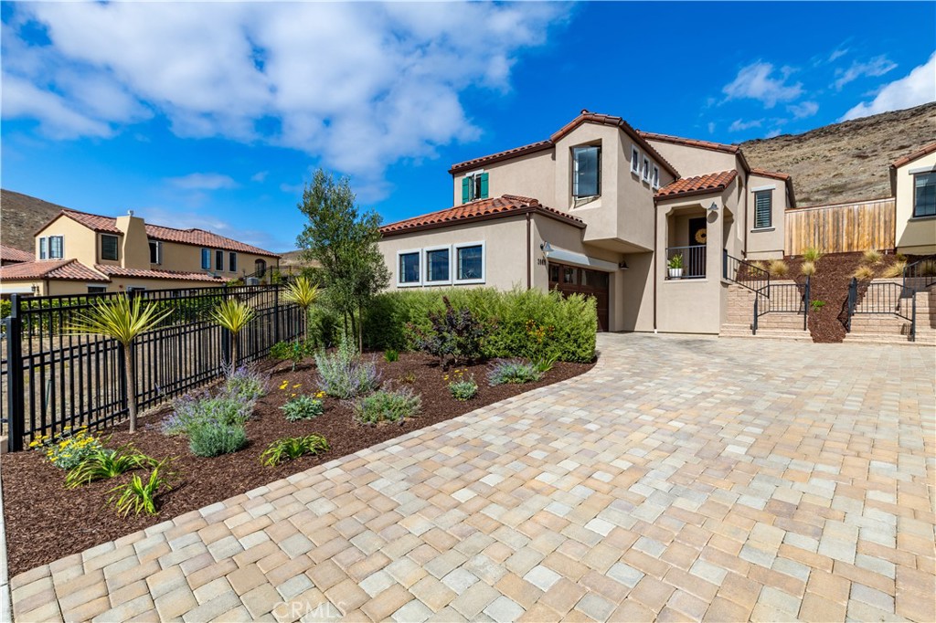 Newly built in 2023 and located in the desirable Toscano neighborhood, this beautifully designed split-level home combines modern upgrades with thoughtful details throughout. Featuring 3 bedrooms and 3 bathrooms, the layout is both functional and inviting. Upstairs, you’ll find two bedrooms and bathrooms, including the spacious primary retreat with a walk-in closet and luxurious en suite complete with double sinks, a walk-in shower, and a private water closet. The open-concept kitchen seamlessly connects to the living and dining areas, offering upgraded cabinetry, granite countertops, a single basin sink, modern backsplash and stainless appliances including a gas range, microwave, and dishwasher. A breakfast counter and dining nook provide multiple spaces to gather. High ceilings and dual sliders fill the living space with natural light, while a cozy gas fireplace and stylish shutters add warmth and charm. Quality finishes run throughout the home, with tile, LVP, and upgraded carpet flooring. Downstairs offers another bedroom, full bath, 2 car garage and laundry room with counter space. Additional highlights include Nest thermostat, Schlage keyless entry, under-staircase storage, and upgraded window treatments - Herman Miller in the primary suite and motorized dual-function treatments in the guest bedrooms. Situated on a premium end-unit lot backing to open space, this home is set in an ideal central location minutes to Downtown San Luis Obispo. A recent professional landscaping refresh enhances the front yard’s curb appeal, while nearby hiking trails, parks, and schools make it a Central Coast dream!