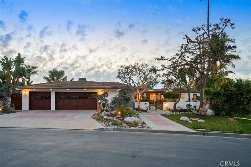 Set within the prestigious, guard-gated enclave of Monarch Bay, this stunning single-level estate offers nearly 5,000 sq. ft. of refined coastal living on one of the community’s largest lots. Located on a tranquil cul-de-sac, the home welcomes you through an expansive gated courtyard into a sprawling retreat designed for both relaxation & entertaining. The lush grounds feature a covered patio w/skylights, an inviting outdoor fireplace & views of Three Arch Bay’s hills & evening lights. Beyond the grand custom entry door, the magnificent great room boasts soaring ceilings, stacked-stone columns, & a floor-to-ceiling marble fireplace, with glimpses of the ocean. The spacious kitchen features stone countertops, an island, stainless steel appliances, an oversized walk-in pantry, & a gracious nook. The expansive primary suite is a private sanctuary, complete with a cozy fireplace, a large walk-in closet, & a French door leading to the serene rear yard. Its luxurious spa-like bath showcases an oversized frameless glass shower, a clawfoot soaking tub & heated towel rack. A secondary primary suite offers elevated ceilings, a walk-in closet, a remodeled marble-accented bath, & a French door opening to the ocean-facing backyard. Designed for versatility, the home also includes two additional bedrooms plus an oversized bonus room featuring an exotic wood ceiling, a stone fireplace, and French doors leading to the courtyard. The rear yard is a peaceful oasis w/mature trees—including Japanese pine, grand magnolia, and oak—complemented by custom stone benches, onyx lighting, a relaxing sauna & views. Additional highlights include exquisite 24” Celini Argento tile, luxuriously remodeled bathrooms, custom lighting, solid wood doors, spacious laundry room with/custom marble pet-washing shower & a massive three-car garage. A separate casita serves as a private office or gym, offering picturesque views of the front grounds & hillside beyond. Residents of Monarch Bay enjoy exclusive access to resort-style amenities including tennis & pickleball courts, a community & dog park, a playground, and the spectacular private beach club—complete with an indoor-outdoor bar, beachfront dining, firepits, & towel, chair, & umbrella service. Ideally located near hiking trails, world-class golf & surfing, & premier coastal resorts like The Ritz-Carlton, Waldorf Astoria & The Montage, this exceptional property is also set to benefit from the exciting Dana Point Harbor revitalization project.
