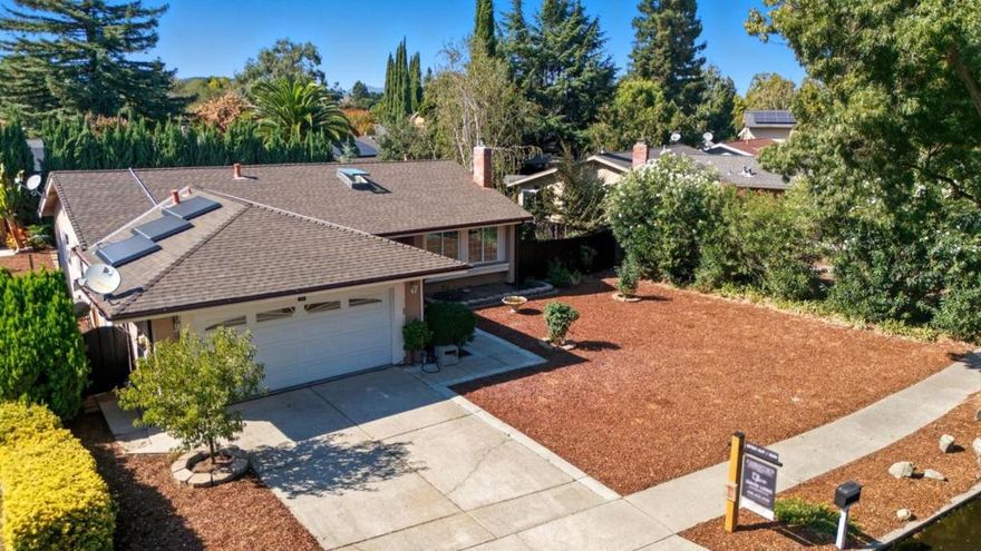 Peaceful Gilroy Living on a Spacious Lot, nestled on a mature tree-lined street, just steps from Christmas Hill Park and the Uvas Creek Nature Preserve trail system.  This updated single-family home sits on an expansive, 8,000+ sq. ft. lot a blank canvas ideal for an ADU or future expansion. Inside, the open-concept kitchen features newer appliances and smart storage with pull-out drawers. Both the primary and hallway bathrooms shine with high-end designer remodels, showcasing Italian marble and hand-crafted Moroccan tile.  Recessed lighting throughout the home.  Sustainability meets modern living with a 7kW Tesla solar system, Powerwall 3 13.5kWh home battery, plus EV chargerpower your home and car while living off-grid in summer. Other recent upgrades include skylights, a cozy wood-burning stove conversion, new sewer lateral, water softener and grit filter, plus reverse osmosis filtration.  Come experience this beautifully upgraded Gilroy home and all it has to offer!