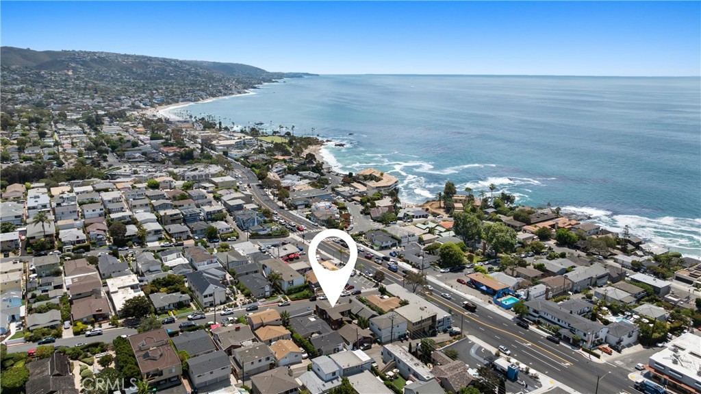 Welcome to 222 Wave Street, a once-in-a-generation opportunity in the heart of North Laguna Beach. Nestled just off Pacific Coast Highway and moments from the iconic shores of Shaw’s Cove and Crescent Bay, this exceptional coastal triplex—complete with a bonus studio—has been cherished by the same family for nearly 40 years. Not offered for sale since the 1980s, it now presents a rare chance to own a piece of paradise in one of Laguna's most coveted areas. Set on an expansive lot with two distinct buildings, the front structure features two spacious units. On the upper level, a two-bedroom, two-bath home boasts unobstructed ocean views. Whether you're relaxing in the living room or enjoying the sunset on the private deck, the endless ocean is your constant backdrop. Inside, the vaulted beamed ceilings elevate the open-concept living room and kitchen and offers two bedrooms and two updated bathrooms. Below, the ground-floor three-bedroom, two-bath unit is ideal for those who prefer single-level living without compromising proximity to the ocean. Between the two buildings lies a sitting area, a tranquil courtyard setting perfect for morning coffee or entertaining guests. At the rear of the property, the second building includes a one-bedroom, one-bath unit with a bonus loft—an ideal spot for an additional sleeping area or storage. Tucked behind is a fully equipped bonus studio featuring its own kitchenette, bathroom, and lofted sleeping space. The property has been thoughtfully improved over the years with modern touches, including updated flooring, quartz countertops, stainless steel appliances, custom shaker cabinetry, custom tile backsplashes, shower finishes, new vanities, recessed lighting, windows, sliding doors, and more. The updates blend effortlessly with the home's original character, preserving its classic Laguna charm while offering contemporary comfort. Adding even more value and convenience, 222 Wave includes an oversized front driveway—an incredibly rare feature in this neighborhood—with parking for up to four vehicles. Whether you're looking for an income property, a vacation home, or a combination of both, this Laguna gem is an extraordinary find. Just a short stroll from world-class beaches, renowned dining, boutique shopping, and beloved local events like the Pageant of the Masters and Sawdust Festival, the best of Laguna Beach truly surrounds you. Don't miss this rare coastal treasure—properties like this almost never come to market.
