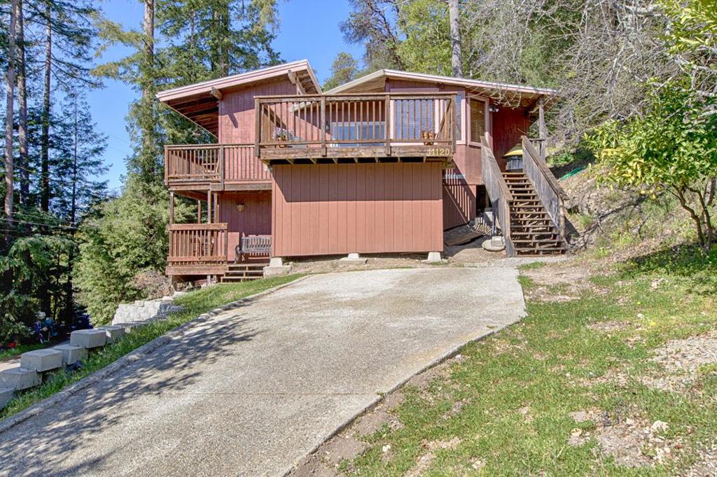 CONTRACTORS AND INVESTORS! This can become your dream retreat. While some work is needed, it remains comfortable and attractive in its current condition, offering a fantastic investment opportunity for a builder or buyer with construction experience. It features new stainless-steel appliances, a vaulted ceiling, outdoor storage and ample parking. The home is currently divided into two units: the upper level is a spacious, sunlit one-bedroom, one-bath home with vaulted ceilings and an open floor plan. The lower level is a delightful studio apartment with its own deck and private entrance. This flexible layout provides the option to easily convert this home into a two-bedroom, two-bath configuration. The expansive deck offers beautiful views of mountains and a forested canyon, making it ideal for entertaining, relaxing, or outdoor work. Surrounded by nature, your new home is just a short drive to the shops, stores, and restaurants of Felton and Scotts Valley. As you drive through the lush forest along Lompico Road, following the river through an enchanting canyon, you'll feel as though you're on a perpetual vacation in the redwoods. The 3/4+ acre lot may accommodate a second home or guest house, offering even more possibilities for this unique property.