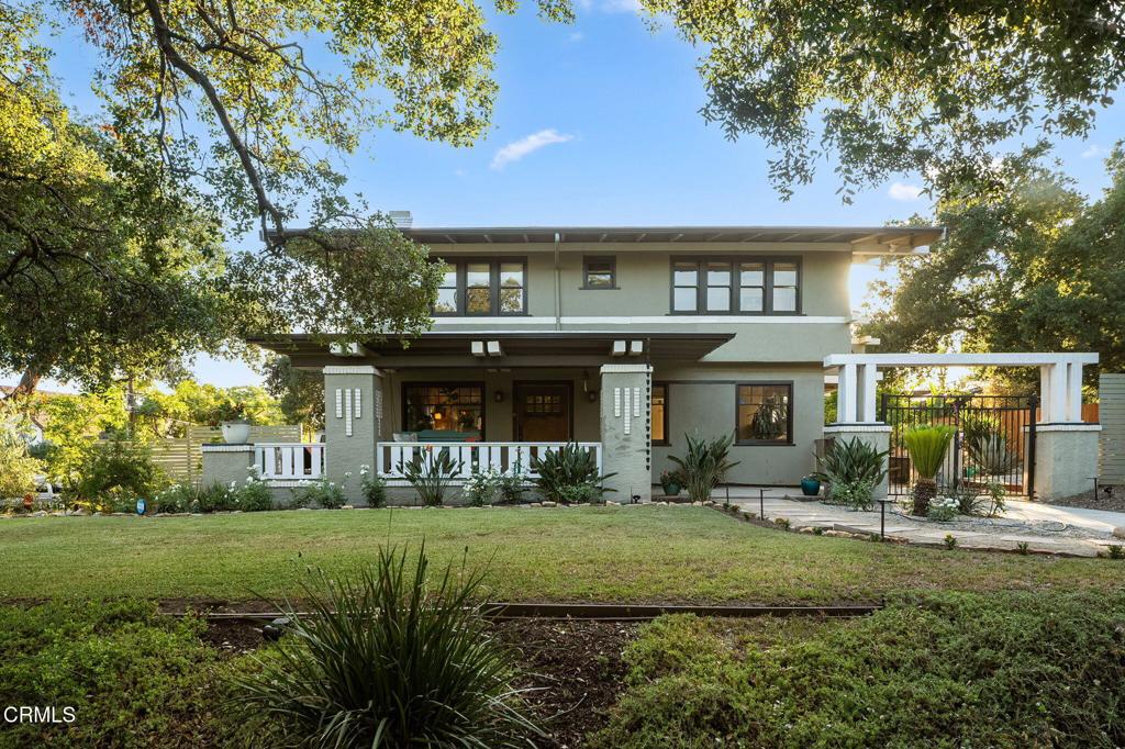 Resting on an expansive, beautifully landscaped corner lot in a picturesque pocket of Pasadena, 1215 N Sierra Bonita Ave makes an unforgettable first impression. A brilliant example of Prairie School architecture at its finest, this historic home radiates character. Even the most stressful days fade on the wraparound porch, glass of wine optional. Inside, the spacious, light-filled layout is tailored for everyday joy--starting with the welcoming living room where hardwood floors, a grand fireplace, and peaceful neighborhood views create a warm environment. Continue to the dining room with original built-ins and an array of windows that cast a soft, ambient glow. The stylishly updated kitchen is bright, spacious, and well-appointed with a cozy breakfast nook. Upstairs, the primary suite is wrapped in windows and provides its own sitting area along with a sumptuous ensuite bath, perfect for luxuriating. Each of the remaining three bedrooms comes with its own special perk--whether it's an ensuite bath, walk-in closet, balcony access, or an extra art space. The home's massive back and side yards combine to create your own private park. Multiple entertaining areas, a grassy lawn, a bocce ball court, and a firepit invite joyful entertaining and play. What's more, the detached 2-car garage has been thoughtfully converted into a light-filled yoga studio, while a spacious California basement serves as a delightful theater room. Here at 1215 N Sierra Bonita Ave, you'll savor a timeless blend of comfort and charm that never goes out of style.