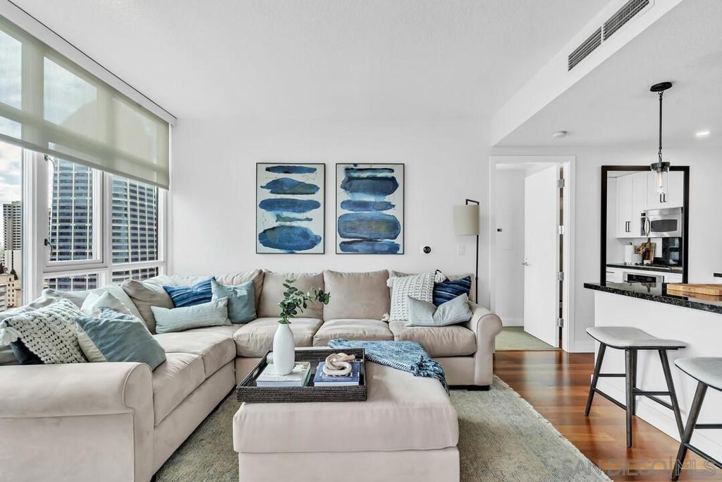 Large, nicely-furnished 1 bed/1.5 bath condo with breathtaking views on the 19th floor! Live in a premier building with premium amenities just a few blocks from Little Italy. Enjoy the open layout, large patio, triple pane floor to ceiling windows, electric fireplace and more. Reserved underground parking space with outlet for EV hookup. Building amenities include concierge, gym, swimming pool, sauna, steam room and a 1 BR apartment rental available for your out of town guests. Available 2/1/25.
