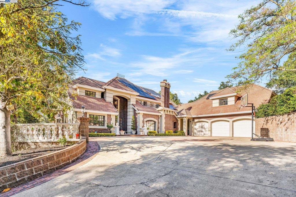 Gorgeous grand custom gated home, in one of Alamo’s most sought-after locations. With panoramic views from nearly every room, soaring ceilings, a floating staircase, floor-to-ceiling European windows, and timeless elegance. Formal dining with one of three fireplaces throughout this stunning home, elegant living room with a central bar/wine cellar, a Stately family room w/ a stone fireplace, a Parisian-style kitchen with French cabinetry and top-tier appliances, and a ground-floor bedroom suite. Luxurious primary bedroom suite with spa bath. Multiple balconies, Roundhill golf course/ Mt Diablo views. Custom Millwork throughout- resort-style backyard featuring pool, spa, firepit, and peaceful sounds of fountains add to the tranquil atmosphere, while the expansive lot offers vineyard potential, ideal for the discerning buyer looking to cultivate a boutique wine experience or create a private orchard. A true entertainer's delight with solar + attached accessory dwelling unit (ADU), which expands living space and versatility. This ADU is fully equipped with its own amenities, offering comfort and privacy for guests or extended fam/ 3 car garage + 1 car pad. Walkable to downtown Alamo and award winning schools. Less than 1 mile to Roundhill CC with swimming, bocce, tennis and golf.