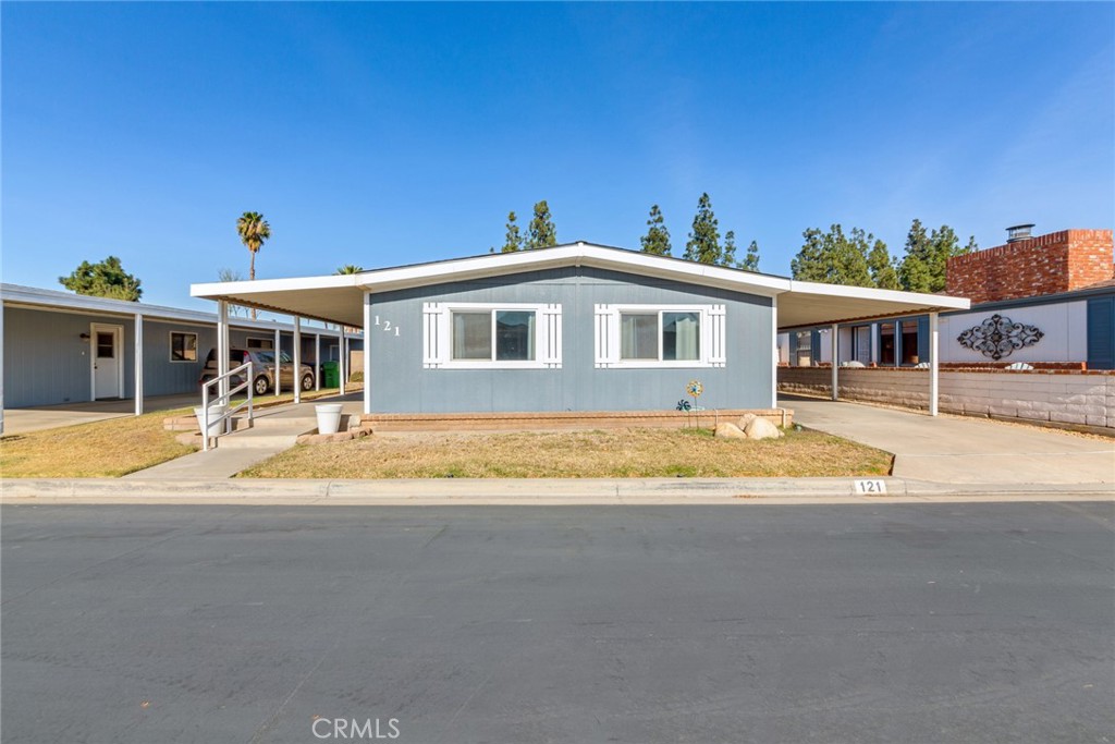 A must see.... this charming 3-bedroom, 2-bathroom manufactured home located in the beautifully maintained, gated 55+ community of Corona Palms. Built in 1983, this single-story residence offers an inviting layout perfect for relaxation and easy living. The bathrooms have been thoughtfully updated. The kitchen features durable laminate countertops, a gas range and a dishwasher. The kitchen is open to the living and dining areas. The laundry area is located right off the kitchen. The home has updated windows installed just 5 years ago, a newer roof, and a newer air conditioner for added comfort and peace of mind. A recently installed water heater ensures efficiency and reliability. A covered front porch area and a two-car tandem carport with two sheds staying with the property. Step outside to enjoy a small backyard space, perfect for low-maintenance outdoor living. This exceptional community offers a range of amenities, including a clubhouse and a pool, all meticulously cared for to provide a serene and welcoming environment. Please note that park approval is required prior to offer acceptance. Don’t miss your opportunity to enjoy a relaxed and fulfilling lifestyle in this desirable 55+ community.