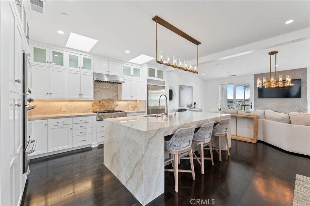 Luxury, Lifestyle, Ocean View and the exclusivity of Corona Del Mar. This highly customized and upgraded property lives like a single family home in the heart of Corona Del Mar. Walkable to the beaches (Private gate access to multiple beaches including baby CDM Beach) and the downtown village. Special attention to detail was given to every aspect of this property. From the floor plan to the subtle finishes. No stone was left unturned in the renovation including a gourmet kitchen that features quarts countertops, stainless thermador oven, wine fridge and upgraded stainless appliances. Perfect for those that love to entertain and the culinary experience. From the moment you arrive, the solid core doors, finest hardware finishes, fixtures and hardwood floors leave an impression of elegance. This home is perfect for entertaining, enjoy the ocean view and breeze for your main level balcony. Each of the spacious bedrooms features an on suite bath. There is a full steam shower, jacuzzi tub and custom tile work throughout. Two car side by side garage with large driveway. Private courtyard and patio area perfect for an evening by the fire with a glass of wine. Set up your exclusive showing today.