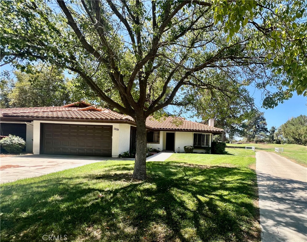 This stunning, move-in-ready home in the highly desirable 55+ Seven Hills Golf Resort showcases panoramic golf course views from nearly every room and offers easy access to the pool and spa, Diamond Valley Lake, Temecula wine country, Palm Springs, snow-covered mountains, and the Idyllwild music scene—with San Diego, Los Angeles, and the Pacific Ocean just down the freeway. Featuring approximately 1,568 sq ft of living space, the home boasts beautiful hardwood flooring in the entry, hallways, and guest bathroom, freshly painted interiors with acoustic ceilings removed, three bedrooms, two bathrooms, and an oversized two-car garage with laundry area and French doors that open to the exterior—ideal for an office setup. The concrete driveway accommodates up to four vehicles, while the spacious living room offers cathedral ceilings and a gas log-burning fireplace. The kitchen is equipped with ample cabinetry, upgraded quartz countertops, gas cooktop, built-in oven and microwave, dishwasher, garbage disposal, and refrigerator, with corner windows above the sink framing serene golf course views. A formal dining room with lighted ceiling fan, sliding glass doors, and custom wood shutters opens to a covered back patio perfect for entertaining. The master suite includes a lighted ceiling fan, sliding glass doors with custom wood shutters, mirrored wardrobe closet doors, and a master bath with tile countertops, dual vanity sinks, and a step-in shower stall with handicap grab bar. Additional bedrooms include a guest room with wardrobe closet and ceiling fan, and a third bedroom with lighted ceiling fan and golf course views ideal as a den or office. The guest bathroom features a shower/tub combo, tile vanity, and hardwood flooring. With LOW TAXES and HOA FEES of approximately $330/month covering water, trash, exterior landscaping, pool, and spa, and close proximity to shopping, dining, medical facilities, and hospitals, this entertainer’s dream home offers the perfect opportunity to retire in style.