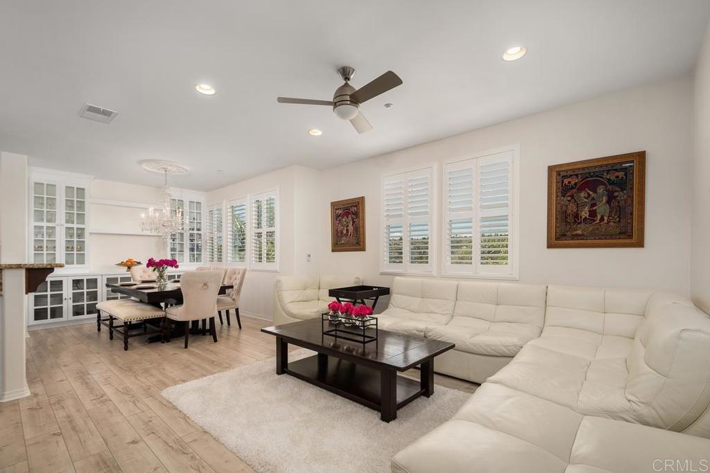 This stunning three-story home in the Avellino community of La Costa Greens features four spacious bedrooms, three-and-a-half bathrooms, and an open-concept layout designed for modern living. The chef’s kitchen boasts granite countertops, white cabinetry, and stainless-steel appliances, seamlessly connected to the dining area and family room. Elegant upgrades include wood laminate flooring, plantation shutters, and beautifully tiled bathrooms. The home also offers energy-efficient features, air conditioning, a two-car garage, and custom built-ins. The first level includes a guest bedroom or office with a full bath and a sitting area, while the main level features the primary suite, gourmet kitchen, and laundry room. The upper level provides a versatile loft space, two bedrooms, and an additional full bath. Residents enjoy resort-style amenities at “The Presidio”, including a pool, spa, gym, clubhouse, and tennis courts. Conveniently located near top-rated schools, restaurants, shopping, parks, and the Carlsbad Dove Library. Virtual Tour: https://tours.previewfirst.com/pw/100437