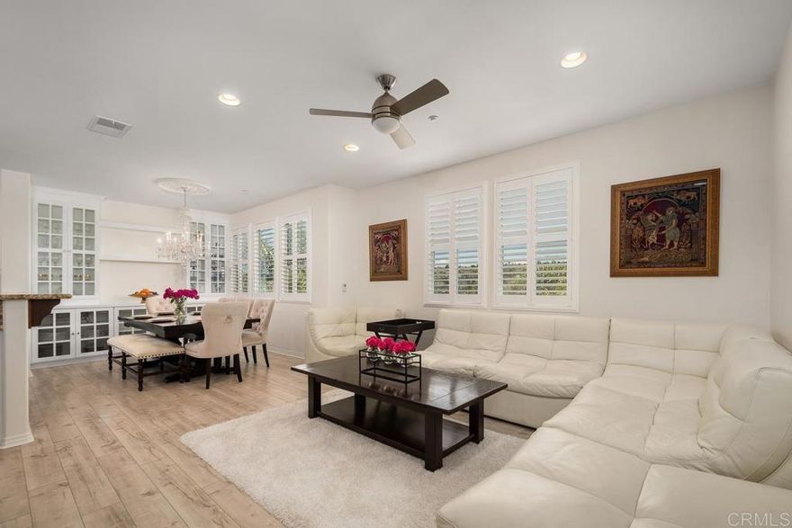 This stunning three-story home in the Avellino community of La Costa Greens features four spacious bedrooms, three-and-a-half bathrooms, and an open-concept layout designed for modern living. The chef’s kitchen boasts granite countertops, white cabinetry, and stainless-steel appliances, seamlessly connected to the dining area and family room.  Elegant upgrades include wood laminate flooring, plantation shutters, and beautifully tiled bathrooms. The home also offers energy-efficient features, air conditioning, a two-car garage, and custom built-ins. The first level includes a guest bedroom or office with a full bath and a sitting area, while the main level features the primary suite, gourmet kitchen, and laundry room. The upper level provides a versatile loft space, two bedrooms, and an additional full bath.  Residents enjoy resort-style amenities at “The Presidio”, including a pool, spa, gym, clubhouse, and tennis courts. Conveniently located near top-rated schools, restaurants, shopping, parks, and the Carlsbad Dove Library.  Virtual Tour: https://tours.previewfirst.com/pw/100437