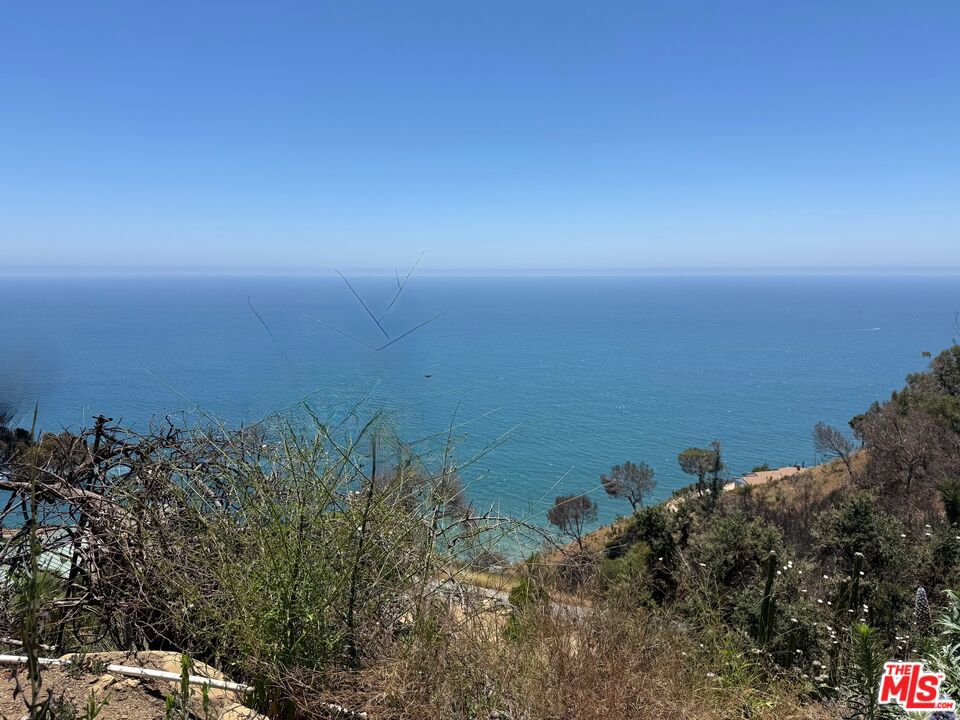 Enjoy breathtaking coastline and city lights views from this dynamic property. Sadly the 5,727 square foot home, with outdoor spa and fire pit, was lost in the Palisades fire, but now is your chance to Design Your DREAM HOME and be the one to experience the beauty for future years. The lots have been cleared and thankfully there are still some beautiful mature trees. Two lots must be sold together (4450-018-014 and 4450-018-016) Electric lines are in the process of being located underground by SCE. The Big Rock area is close to both Santa Monica and Malibu and has a signal at PCH for safe access.