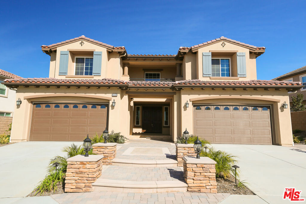 Stunning 6-bedroom, 5.5-bath residence located in the prestigious community of Yorba Linda. Situated on a premium view lot, this two-story home features soaring ceilings, an elegant foyer, and walls of windows that fill the home with natural light. The dramatic dual staircase leads to formal living and dining areas, ideal for entertaining. The gourmet kitchen offers a large center island, high-end appliances, a butler's pantry, and ample cabinetry. The spacious primary suite includes a private retreat and spa-inspired bath. Additional highlights include a versatile bonus room, and luxurious architectural details throughout. Conveniently located near award-winning schools, parks, shopping, dining, and major freeways.