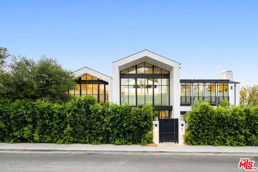 An architectural masterpiece and arguably one of the most unique and special properties in all of Los Angeles.  The centerpiece of this incredible property is a 60 ton floating and spiraling staircase that rises from the 2,000 sq.ft. basement, to the second floor.  Absolutely magnificent design, featuring a beautiful 30 foot plus glass entry that flows through to another 30 foot plus rear glass facade which leads to the backyard.  The property sits on over half an acre and features a builtin BBQ, sunken fire pit, half basketball court with NBA 3 point line, and lots of fresh grass throughout.  The circular driveway gracefully flows from one side to another providing enough space to park plenty of cars.  The aforementioned basement features a theater, bar, wine cellar, lounge, and wellness center with dry sauna.  A must see!!!!