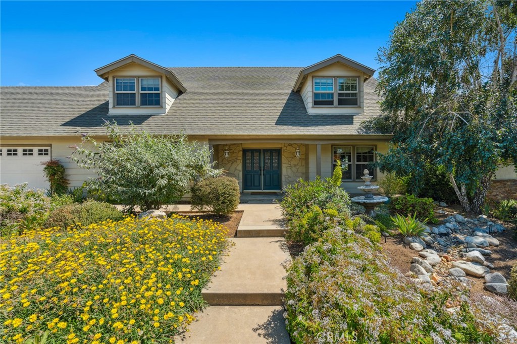 Charming Cottage-Style Home with Lush Award-Winning Gardens and Versatile Layout
Welcome to this warm and inviting cottage-style home nestled in a beautifully landscaped setting. With over 3,300 sq ft of living space (additional 240 sq ft sunroom with its own dedicated heating and cooling), this spacious 5-bedroom, 4-bathroom residence offers comfort, character, and flexibility for a variety of lifestyles.
Step through the beveled glass double-door entry into a home that blends classic charm with modern upgrades. The main level features a private in-law suite complete with double doors, an attached full bath with safety bars, and the ability to be sectioned off with the adjoining family and sun rooms—perfect for multi-generational living or guest accommodations.
Upstairs, you’ll find four more bedrooms, each with walk-in closets, including:
A primary suite with a spa-like bathroom and an expansive walk-in closet.
A secondary suite with its own attached bath.
Two additional bedrooms, one of which includes access to a large unfinished attic-style storage room.
A full hallway bath with a generous walk-in shower.
Enjoy time with loved ones in the large family room, featuring a fireplace, custom cabinetry, a bar with sink, and access to the sunroom—ideal for entertaining or relaxing year-round.
The heart of the home is the bright white country kitchen, enhanced by embossed metal backsplashes, and accompanied by a spacious wash room with pantry, sink, and extra storage. Additional features include:
Recently remodeled bathrooms with updated piping.
Dual-zone central heating and air, plus a whole-house fan.
Soft water system and reverse osmosis filtration in the kitchen.
Outside, you'll find an incredible low-maintenance garden oasis, featuring:
California native, drought-tolerant landscaping.
Brick-paved paths, raised planter beds, and fruit trees (lemon & apple).
Award-winning design (Roger’s Garden California Friendly Garden Award).
Three covered patio areas for relaxing or entertaining.
Drip irrigation system and just twice-monthly maintenance.
The home also includes a 2-car garage with a workbench and built-in shelving, plus driveway parking for three additional vehicles.
This is more than just a home—it’s a lifestyle. Come experience the thoughtful design, natural beauty, and unique charm for yourself.
