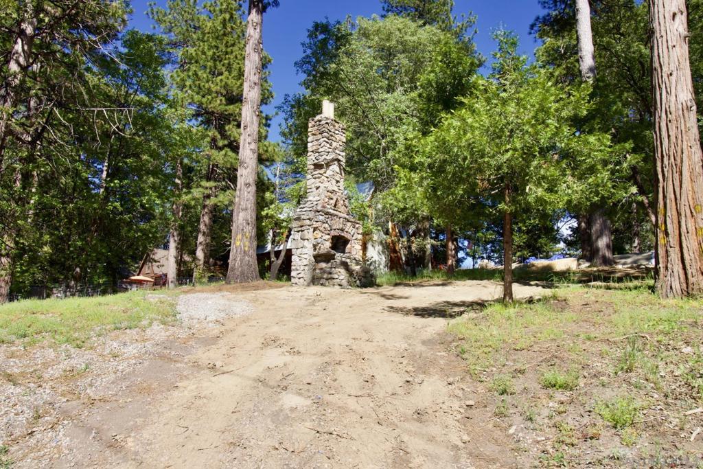 Prime 15,000 SF Mixed-Use Lot in the Heart of Historic Running Springs! Endless possibilities await with this rare mixed-use property located in the charming mountain town of Running Springs - perfectly positioned between Lake Arrowhead and Big Bear. Whether you're dreaming of a mountain getaway, a thriving business, or both, this versatile lot is ready for your vision! Enjoy year-round outdoor adventure with nearby hiking, skiing, fishing, and horseback riding, all surrounded by the natural beauty of the San Bernardino Mountains. Walk to the post office, library, community park, bank, and local restaurants - all just steps away! The property features historic charm with remnants of a 1930s grand stone fireplace - a unique focal point for future development. Recent upgrades including storm drain installation, driveway and upper lot grading, tree trimming and removal, new fencing and gated entry. Water, sewer & electricity are already at the property - just tap in and get started! Mixed-use zoning opens the door to both residential and commercial possibilities. Topographic Maps, Conceptual drawings and Floor plans are available to inspire your dream project. This is more than just a lot - it's an opportunity. ** Don’t let it pass you by!