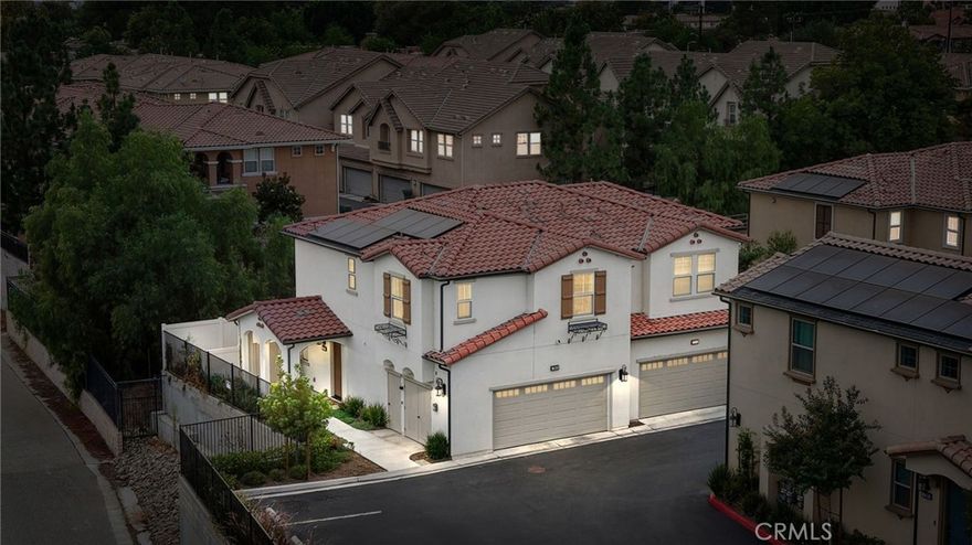 Luxurious 2023 End-Unit Townhome in the Heart of Simi Valley. Tucked away in a quiet, end-of-community location, this stunning 2023-built modern townhome offers the perfect blend of luxury, privacy, and eco-conscious living. As a rare end-unit, it boasts open views, minimal shared walls, and direct access to a serene park and walking path, all while being just minutes from the best of Simi Valley. Step inside to soaring ceilings, luxury vinyl plank flooring, and a bright open floor plan designed for modern living. The upgraded kitchen is a chef’s dream, featuring sleek quartz countertops, white cabinetry, and stainless steel appliances. The spacious living room is framed by custom shutters, picture-perfect windows, and a stylish ceiling fan, seamlessly connecting to the dining area and the expansive private backyard and side yard. Downstairs also includes a convenient powder room and direct access to a 2-car garage. Upstairs, you'll find three generously sized bedrooms, all with plush upgraded carpeting. The primary suite is a true retreat, offering a spa-like bath with a large walk-in shower, dual vanities, and a spacious walk-in closet. A separate laundry room upstairs adds everyday convenience. Additional highlights include: Tankless water heater, HVAC, and furnace – all just 2 years old. High baseboards and crown molding throughout and solar panels! With its prime location, high-end upgrades, and attention to detail, this move-in-ready townhome is a rare opportunity in today’s market. Don’t miss your chance to own this exceptional property in one of Simi Valley’s most desirable communities!