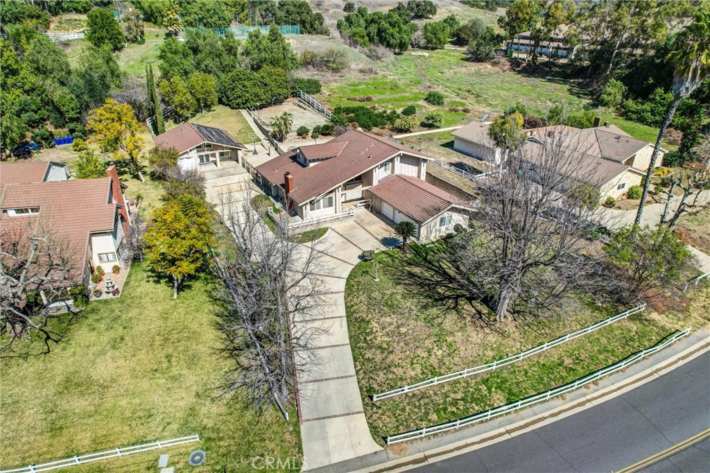 Rare Dual-Home Estate in Prestigious “The Country” Community. Welcome to 22517 Lazy Meadow Drive, a truly unique estate nestled within the exclusive Diamond Bar “The Country” Association. This exceptional property sits on approximately one acre of rare, mostly flat land and features two separate homes—a rare find in this sought-after neighborhood.
Main House:
• 3,522 sq. ft. of living space
• 4 bedrooms, 3 bathrooms
• Spacious three-car garage
• Expansive deck off the main bedroom
• Large covered patio—perfect for outdoor entertaining
• Pool (currently covered and not in use)
Guest House (Built in 2004):
• 1,120 sq. ft. of well-designed living space
• 1 bedroom, 1 bathroom
• Comfortable living and dining areas
• Fully equipped kitchen
• Laundry closet
• Private one-car garage
Located within walking distance to the community clubhouse, HOA pool, tennis courts, pickle ball courts, and horse stables, this property offers unparalleled access to top-tier amenities. Conveniently positioned near the 57 and 60 freeways, it provides easy access to Orange County, Los Angeles, and San Bernardino. Highly-Rated Diamond Bar schools. Properties like this—a nearly flat acre lot with a long driveway and two homes on-site—rarely become available in The Country. Don’t miss this incredible opportunity to own a one-of-a-kind estate in one of Diamond Bar’s most prestigious communities!