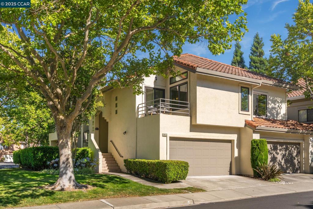 Beautiful corner unit condo in the gated Canyon Lakes community, facing peaceful open space with serene views making it a rare find. This spacious 3-bedroom, 2-bath home lives like a single story, with all main living areas located on one level. Features include an open floor plan with vaulted ceilings, recessed lighting, and sleek flooring throughout. The sunlit kitchen offers granite countertops and stainless steel appliances. The family room includes a cozy fireplace and overlooks a peaceful pond. Living and dining areas open to a private balcony, perfect for entertaining. All bedrooms have walk-in closets. The primary suite features an ensuite bath with dual-sink vanity, large walk-in closet, and a private deck with stunning views. Attached 2-car garage with storage. Resort-style community amenities include pools, spa, tennis & pickleball courts, walking trails, 18-hole golf course, and clubhouse. Located near top-rated San Ramon schools, shopping, parks, walking trails and major commuter routes.