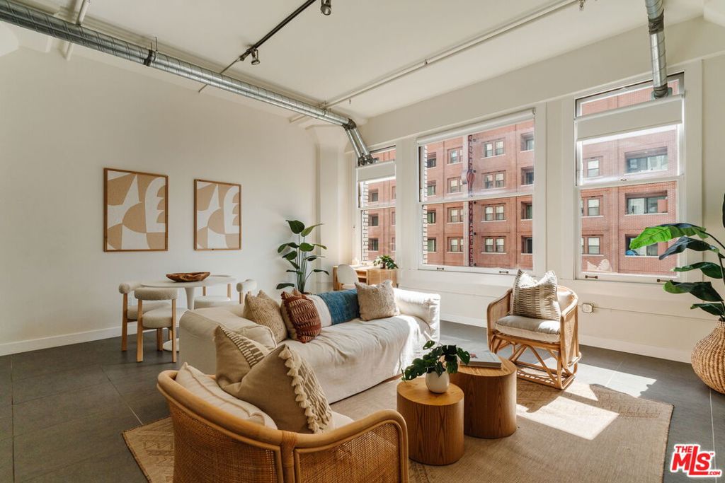 Set in the historic former Western Costume Building, this reimagined 1924 loft delivers soaring ceilings, expansive windows, and bright open-concept living. Completely renovated in 2019, it features stainless steel appliances, quartz countertops, smart home upgrades, custom motorized shades, and in-unit laundry. Amenities include a rooftop pool and spa with cabanas and BBQ, fitness center, and flexible use options, including short-term rental privileges. The building also features a gym, mailroom, and 24-hour doorman. With a Walk Score of 95 and Transit Score of 100, you're surrounded by the best of Downtown: the Orpheum, United Artists, STILE Downtown, shopping, dining, and a future Erewhon just moments away. A rare opportunity to live, invest, and experience one of DTLA's most iconic addresses.