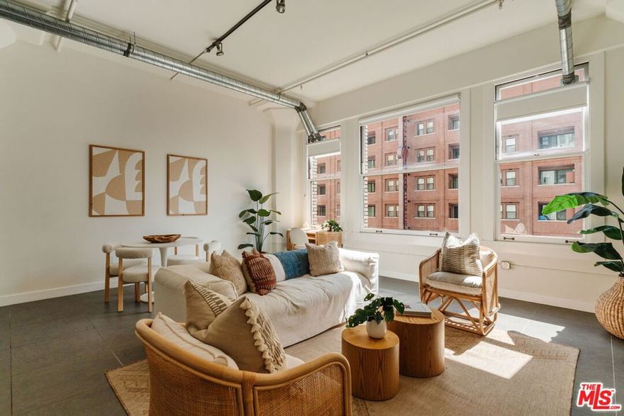 Set in the historic former Western Costume Building, this reimagined 1924 loft delivers soaring ceilings, expansive windows, and bright open-concept living. Completely renovated in 2019, it features stainless steel appliances, quartz countertops, smart home upgrades, custom motorized shades, and in-unit laundry. Amenities include a rooftop pool and spa with cabanas and BBQ, fitness center, and flexible use options, including short-term rental privileges. The building also features a gym, mailroom, and 24-hour doorman. With a Walk Score of 95 and Transit Score of 100, you're surrounded by the best of Downtown: the Orpheum, United Artists, STILE Downtown, shopping, dining, and a future Erewhon just moments away. A rare opportunity to live, invest, and experience one of DTLA's most iconic addresses.