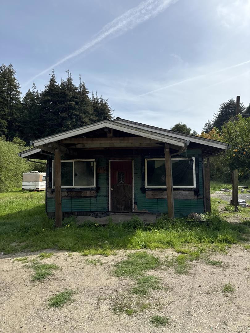 Are you seeking a project with immense upside potential? Look no further! This 1.1-acre approx. property is fully usable offering a unique opportunity for investors and developers alike. With RA zoning, the county permits two homes plus a barn or outbuilding, providing incredible flexibility to create your dream estate or investment property. The property includes one existing fixer-upper home. Enjoy the convenience of two electric meters, two gas lines, and an operational water meter already in place. Septic systems permitted. Sunny, beautiful building areas are set back from the main road, providing privacy and tranquility. The property is to be sold in As Is Condition, and buyers are advised to verify all information with the Santa Cruz Planning Department. Plans for the property will be available at the time of purchase. This property presents a rare chance to capitalize on a versatile and promising piece of real estate. Dont miss out on this exceptional opportunity!