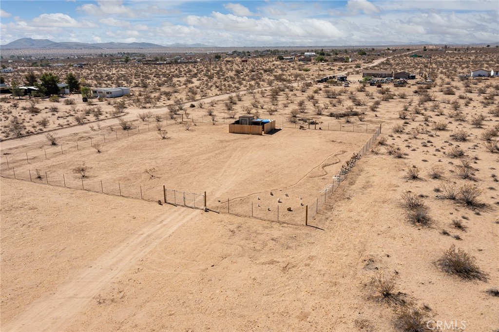 BEST VALUE in LANDERS: 1.99-acres with PAID/INSTALLED/WORKING WATER METER. Installed water meter alone is approximately a $16k value (buyer to check). In addition, property is fenced, has two gates, storage area, makeshift shower. Perfect for camping or hanging your hat. See the pictures. This is a great buy for someone looking to get a start or a great long-term investment. Drive out for the weekend and sleep in your fenced property – or stay the week. For those who have been looking for land they can actually use on the day escrow closes, this may well be your best and only option (buyer to check). Won’t last long. Get while the getting’s good! NOTE: Green lines demarcating boundaries in pictures are approximate, as property has not been surveyed; street address is not official – do not use address or google maps GPS to locate property. To find property, please locate with APN: 0629-372-06