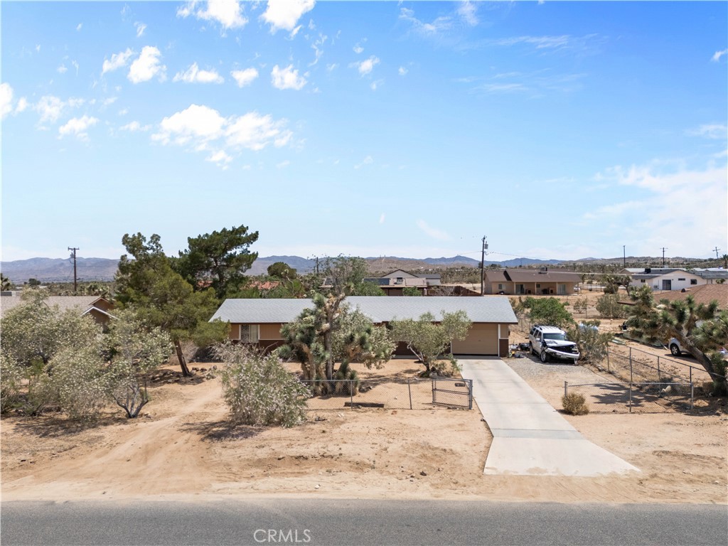 Welcome to a cozy 2-bedroom, 1-bathroom home offering 982 sq ft of living space on a spacious 20,000 sq ft lot. This property includes a 2-car garage and plenty of outdoor space for future possibilities. Located in a peaceful neighborhood, you're just minutes from local attractions like Joshua Tree National Park, Desert Christ Park, and the Hi-Desert Nature Museum. Enjoy nearby shopping and dining in Old Town Yucca Valley, and don’t miss the live music and great food at Pappy & Harriet’s in Pioneertown. Whether you're looking for a weekend retreat, a full-time home, or an investment, this home has the potential to be your perfect desert escape!