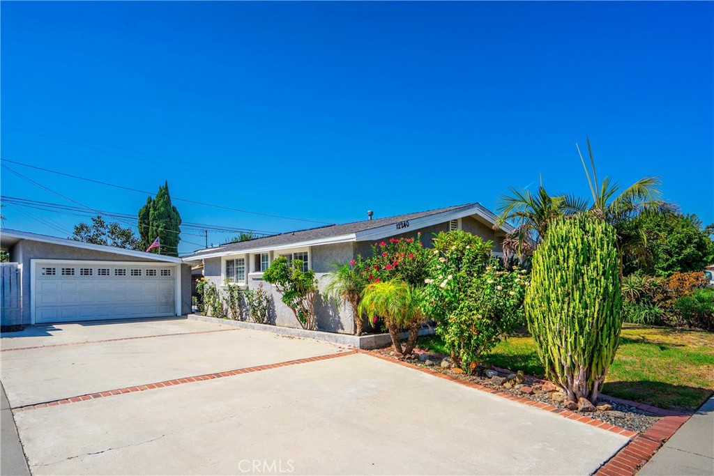 This welcoming 3 bedroom, 2 bathroom home blends comfort with thoughtful updates. The open-concept living area features vaulted ceilings, newer flooring, and plenty of natural light flowing seamlessly into a modern kitchen with quartz countertops, white cabinets, stainless steel appliances, and a large island perfect for gatherings. The bedrooms are bright and airy, while the bathrooms have been updated with clean finishes that are move-in ready. Outside, you’ll find a spacious backyard with mature trees and a built-in outdoor fireplace, ideal for entertaining or relaxing. The detached garage offers ample storage and flexible use. Located near Norwalk Blvd and the Civic Center, the home is close to shopping, dining, parks, and easy freeway access to surrounding cities.