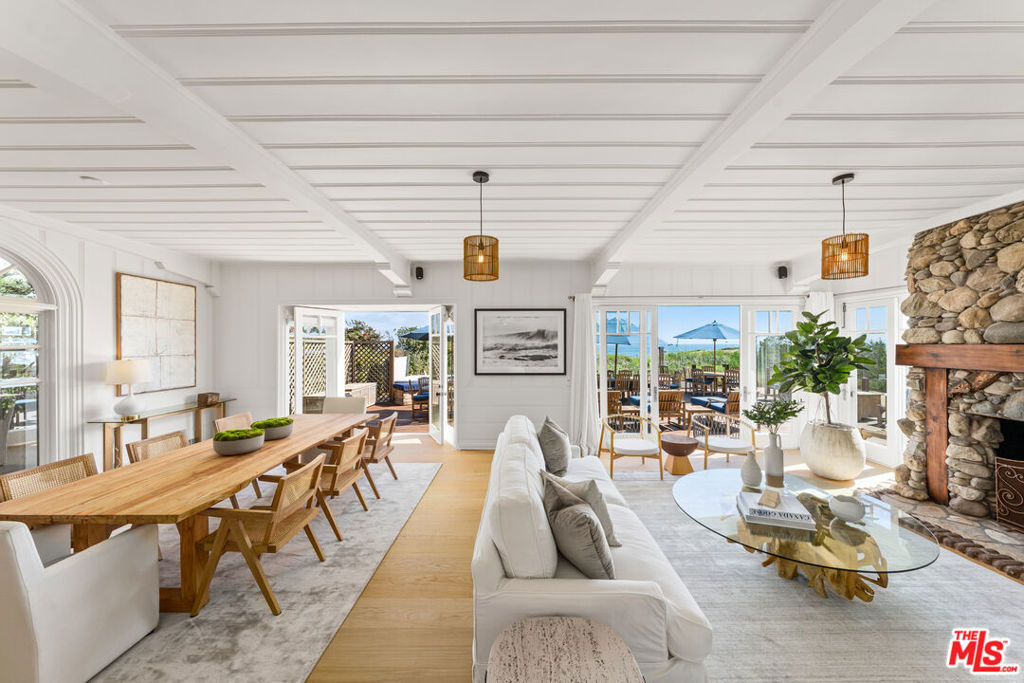 Charming and picturesque Cape Cod beach house on beautiful Broad Beach with 90 ft of beach frontage! This rare offering includes a 4-bedroom main house, 1-bedroom guest house, plus an adjacent lot/separate APN that contains a basketball court and sandy sitting area. Main house features a large chef's kitchen, dining room and family room that open out to deck, TV den, large oceanfront primary suite with sitting area and expansive terrace, and 3 additional guestrooms. Guest house below private garage features 1 bedroom, 1 bath, and laundry room. Large wraparound entertaining deck with spa looks out on picturesque dunes and the Pacific Ocean. Unique spaces include a fire pit adjacent to deck and lounge area atop the dunes perfect for sunset cocktail hour. Zen patio and front lawn with surrounding rose gardens provide a refreshing change of scenery and a safe place for kids to play. Properties can be purchased together or separately. Opportunity to build dream beach compound or keep as-is with unique entertaining and play spaces.