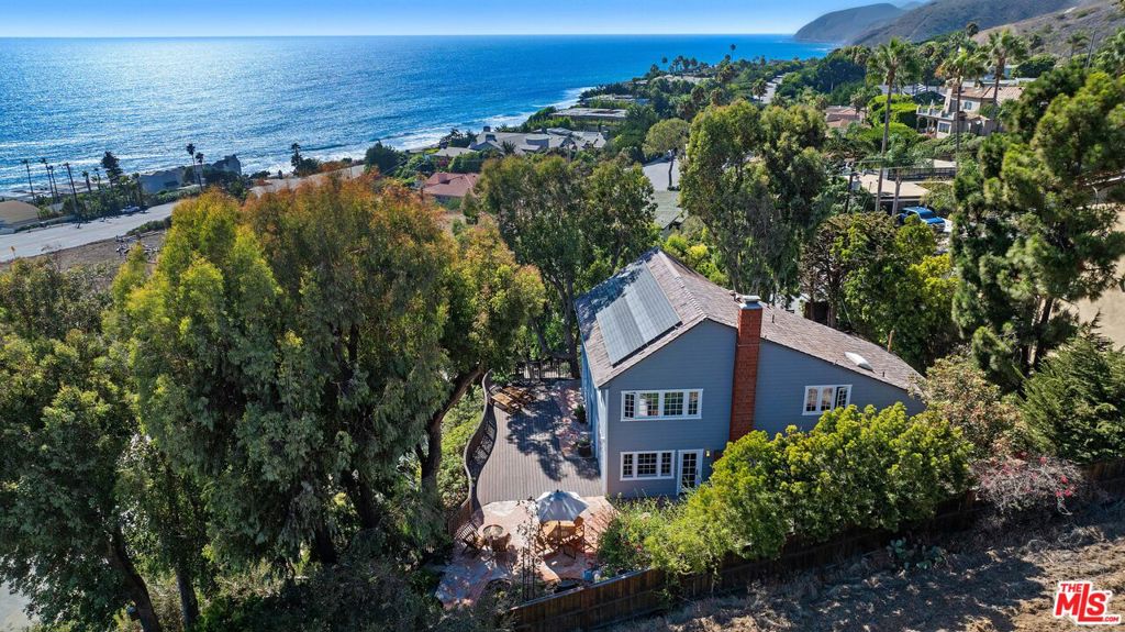 Cape Cod at County Line! First time on the market in 37 years - a rare commodity in this well sought after location with limited SFR's and neighboring properties selling over $20M. Don't miss this Incredible opportunity to acquire this adorable, warm, and ultra-private Cape Cod nestled across from renowned surf spot, County Line. Bright and spacious, this cozy 4 Bed/3 Bath spares no detail. Upon entrance, the generous living area with saltillo tile and custom wood burning fireplace awaits along with abundant natural light and ocean views by way of the ample windows and French doors throughout. Adjacent is the beautifully renovated kitchen complete with elevated finishes including cherry cabinetry, limestone countertops, and upscale appliances. The scenic mountain and ocean views resonate through all four bedrooms and continues through to the Trex decks and expansive backyard where you'll find a sweet enclosed vegetable and fruit garden surrounded by California native landscaping, winding brick and flagstone pathways embedded with sea glass, outdoor shower, and two stone water features which beckon birds and wildlife to the yard. To top it all off, this incredible parcel has a private gated driveway and fully finished 2-car garage with EV charging station, Tesla Powerwall for any unexpected outages, Solar Roof, newly installed Hardie Board non combustible siding, Roof sprinklers, and so much more. Truly a well thought out vision and a beautiful opportunity not to be missed!