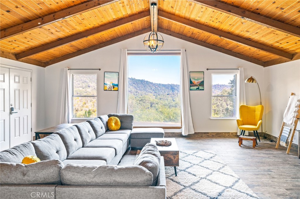 5.5 Acres of Tranquility & Panoramic Views!
Welcome to your private mountain sanctuary, perfectly positioned on 5.5 picturesque acres with sweeping views of the majestic Sierra Nevada.
The main residence is a charming 3-bedroom, 2-bathroom home thoughtfully situated at the top of a gently winding driveway. From the front rooms, enjoy breathtaking mountain vistas, while the shaded back porch and private hot tub offer a peaceful retreat among the trees. Inside, a vaulted knotty cedar ceiling adds rustic elegance to the open-concept great room, which has been tastefully remodeled to elevate both comfort and style.
The updated kitchen boasts stone countertops and newer appliances, seamlessly connecting to a spacious dining area—ideal for hosting friends, family, or guests. The entire home has been recently refreshed with new interior paint, carpet, and sliding doors, creating a bright, welcoming atmosphere throughout.
Each bedroom enjoys mountain views from every window, while the primary suite offers a walk-in closet, private en-suite bath, and direct patio access. A second bedroom also includes patio access and a walk-in closet, and the third shares a well-appointed bathroom. Don’t miss the permitted 400 sq ft game room—a perfect hangout spot filled with fun and laughter. The newer roof with solar adds both value and sustainability. Solar loan assumable.
A true highlight of the property is the second home: a 2018 manufactured residence that is fully handicap accessible, featuring 2 bedrooms, 2 bathrooms, and a thoughtfully designed 920 sq ft layout. Stone countertops, an open and airy design, and a full-length covered porch with a custom wheelchair ramp make this a comfortable, inclusive space for all.
Outside, the property shines with a recent landscape makeover, creating countless spots to relax in the shade, sway in a hammock, or gather for picnics under the open sky. Cool breezes sweep in daily—from gentle morning drafts rising from the valley to crisp evening air drifting down from Yosemite. And with a new well pump, you’ll have ample water year-round.
This rare dual-home mountain retreat offers unmatched opportunity in a truly stunning setting.
